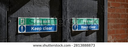 Fire exit keep clear sign on construction building site door