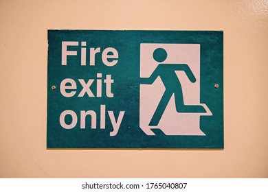 Fire Exit Only Sign With Icon Of Person Running Green And Beige Coloring