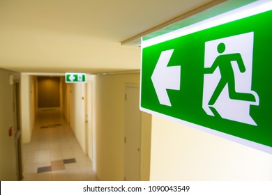 Fire exit sign at  the corridor in building