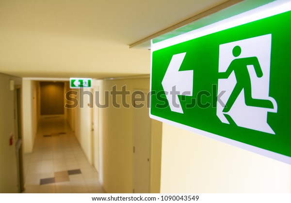Fire exit sign at \
the corridor in building