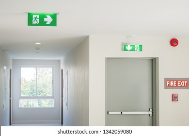 Fire Exit Sign With Light On The Path Way In The Hotel Or Office