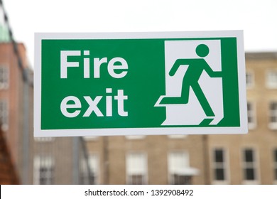 Fire Exit Sign In A Public Building. Fire Escape Route Signs On A Glass Door