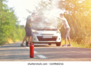 Fire Extinguisher Against Car Incident On The Road With Smoke On The Engine