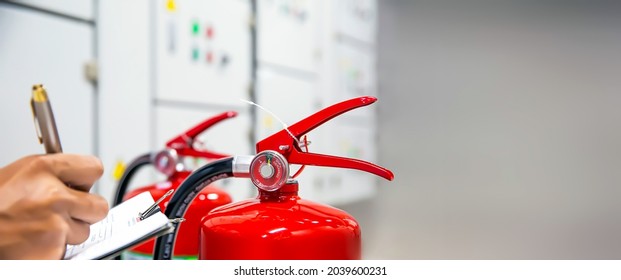 Fire extinguisher, Engineer inspection and checking pressure gauge level of fire extinguisher tank with fire hose cabinet of protection and prevent for emergency and safety rescue and fire training.