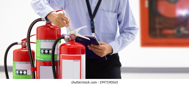 Fire extinguisher, Firefighter use inspection list checking pressure gauge level of fire extinguisher tank in the building of protection and prevent for emergency and safety rescue and fire training.