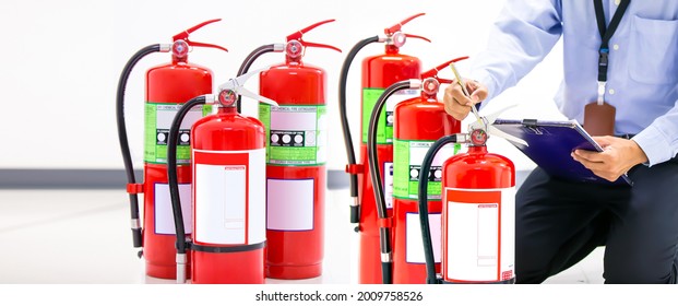 Fire Extinguisher, Firefighter Use Inspection List Checking Pressure Gauge Level Of Fire Extinguisher Tank In The Building Of Protection And Prevent For Emergency And Safety Rescue And Fire Training.