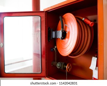 Fire extinguisher with various types of fire extinguishers Located In the white wall. copy space for text and content