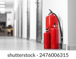 Fire extinguishers on floor in hall, space for text