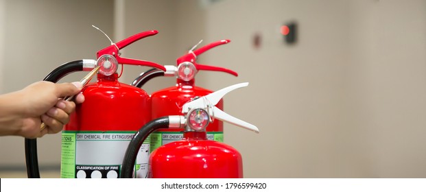 Fire Fighter Are Checking Red Fire Extinguishers Tank In The Building Concepts Of Fire Prevention Emergency And Safety Rescue Of Fire Services And Training.