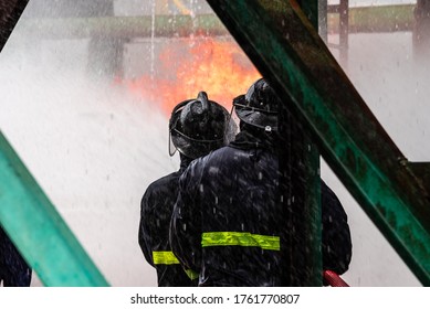 Fire Fighter Drill On The Petrochemical Burning Scene. Prepare To Respone, Use Equipment And Understand Strategy.