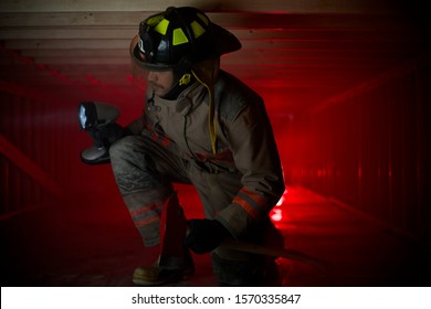 Fire Fighter On One Knee In Crawl Space 