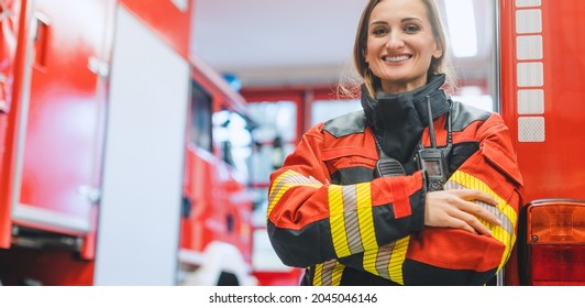 Fire Fighter Woman Standing In Front Of A Fire Truck