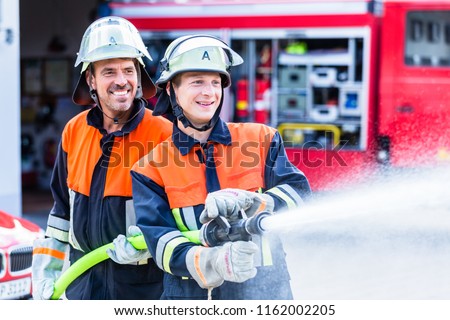 Fire fighters from fire brigade extinguish fire
