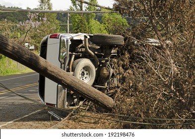 Fire Fighters And Police At A Single Vehicle Accident That Rolled And Hit A Power Pole And Trees Resulting In Minor Injuries To The Driver.