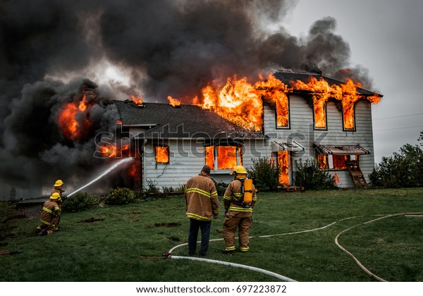 Fire Fighters Putting\
Out A House Fire