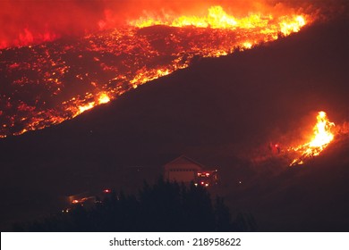 Fire Fighters Try To Save A Home From Forest Fire As Flames Rapidly Approach The House.   The Carlton Complex Fire - WA State's Biggest Wild Fire In History.  100's Evacuated And Dozens Of Homes Lost