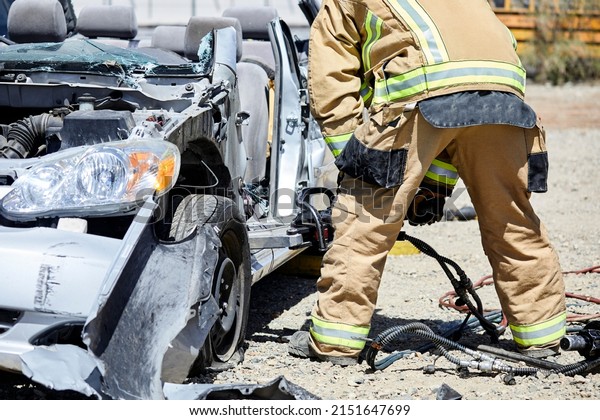 Fire Fighters using the Jaws of Life to\
dismantle a car during a\
demonstration