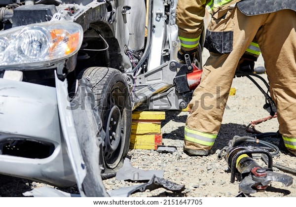 Fire Fighters using the Jaws of Life to\
dismantle a car during a\
demonstration