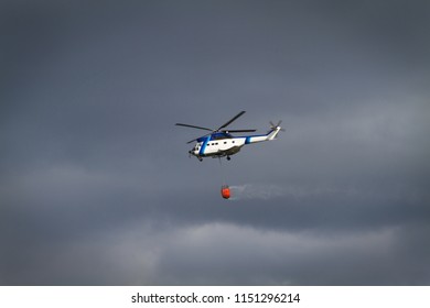 Fire fighting helicopter. Forest fire problem concept