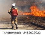 Fire fighting in a major fire. Female firefighter in smoke. High quality photo