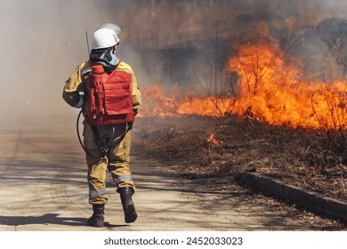 Fire fighting in a major fire. Female firefighter in smoke. High quality photo - Powered by Shutterstock