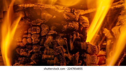 Fire in the fireplace. Aged wood smells wonderful, so if you're going to burn it, choose logs for the smoky, musky smell. Use kiln-dried logs to show your love for the environment. - Shutterstock ID 2247856855
