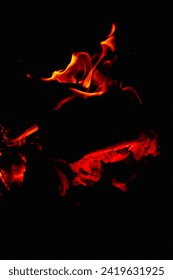 Fire in the fireplace black background. Red and yellow flame blaze, thermal energy during the night. Bonfire flares