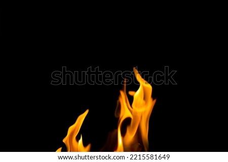 Fire flame concept, flame of fire burning on black background, yellow and red flame glowing burn to energy of heat show power of nature of fuel, bright fire flame for creative design beauty wallpaper