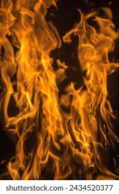 Fire flame element without smoke in red orange yellow color hot with dark background texture closeup detail abstract photography