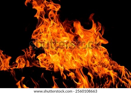 Fire flames on black background. Fire sparks background. Abstract dark fire flames background. Background of flames blazing.