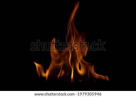 The fire flames is powerful , Shoot in a studio with a black background. 
