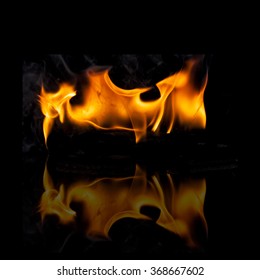   fire flames with   reflection, on a black background.