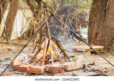 Fire In The Hearth Of Stones In Forest For Cooking. Selective Focus, Blur.