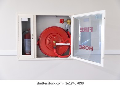 Fire Hose Reel And Fire Extinguisher In Hotel Corridor