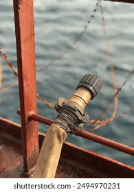 The fire hoses, fixed and kept ready, on the guard rails of merchant ships is a normal procedure when these ships passes through piracy affected areas. High pressure water from these can stop pirates