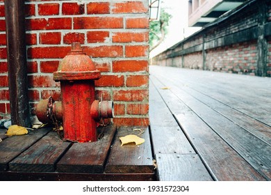 A fire hydrant and brick wall