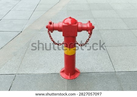 Fire Hydrant with Copy Space. A fire hydrant stands prominently within an urban Singapore setting with open space available for graphic design. The image represents emergency infrastructure, fire prevention, public safety, municipal services, and urban preparedness.