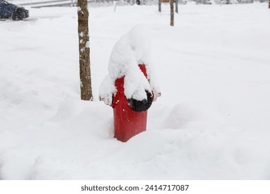 A fire hydrant covered in a deep snow after a snow storm