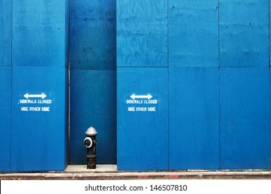 Fire Hydrant In Front Of A Blue Painted Construction Wall In New York City