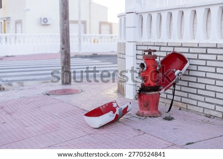 Fire hydrant in a street. Opened red fire hydrant on the street.
