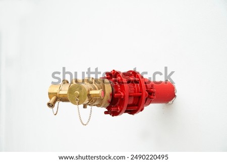 fire hydrant system powerful on the white cement wall
