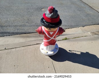 A Fire Hydrant With A Winter Hat Stuck On Top Of It.