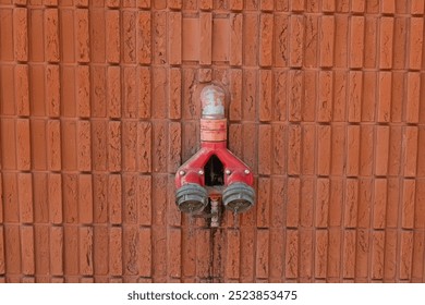 Fire hydrants on the background of a red brick wall.
