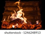 Fire inside a closed brick built oven where logs are burned, being prepared to host the turkey.