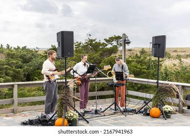 Fire Island, New York - October 9, 2021 : A band playing live music at the Keeper's Craft Tasting beer festival at the Fire Island Lighthouse. Long Island New York