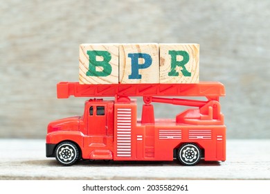 Fire Ladder Truck Hold Letter Block In Word BPR (Abbreviation Of Business Process Reengineering Or Batch Processing Record) On Wood Background