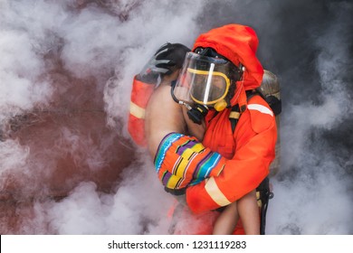 Fire Man Carry The Victim Child Out Of Thick Smoke And Fire