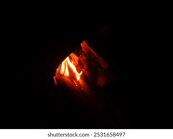 fire in the midst of darkness. wood fire burning in traditional stove. fire and wood. Cooking with traditional stove - Powered by Shutterstock