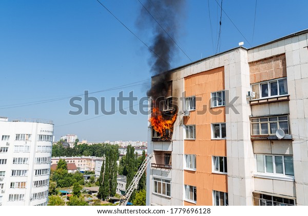 fire on the balcony of a multi-storey\
building, black clouds of smoke, apartment smoke, extinguishing\
fire in a residential building, fire escape,\
emergency