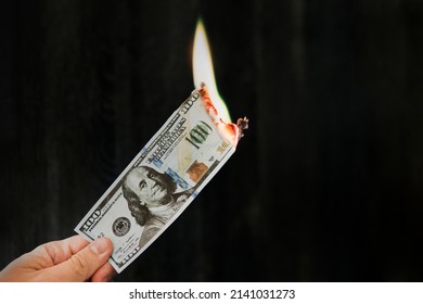 Fire On Banknotes On A Black Background. Concept Of Inflation, A Decrease In The Purchase Of Foreign Currency, And Devolution. Abandoning The Dollar